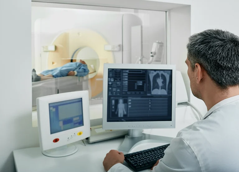 CT Technologists Views Lungs Of Patient During CT Scan