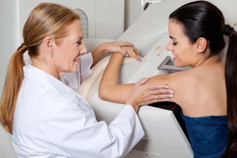 Mammogram Technologist Helping Female Patient During 3D Mammogram