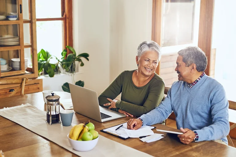 Happy Couple Planning Their Budgets Around Healthcare Expenses For The New Year