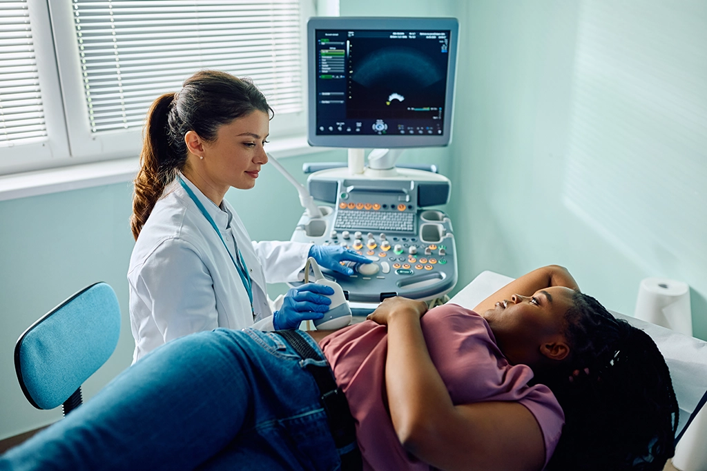 Technologist Performing Ultrasound On Patients Abdomen