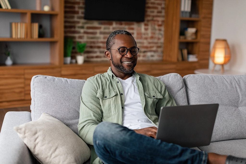 Adult Man Smiling After Looking At Cardiac Care Options